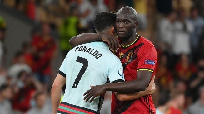 Pemain Belgia Romelu Lukaku memeluk Cristiano Ronaldo usai pertandingan dalam babak 16 besar Piala Eropa 2020 di La Cartuja Stadium, Seville, Spanyol, 28 Juni 2021 dini hari WIB. [AFP/Photo]