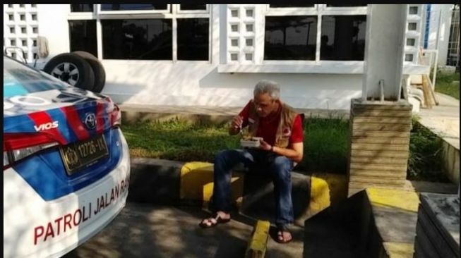 Gubernur Jawa Tengah, Ganjar Pranowo tengah asyik menikmati makanan di belakang mobil patroli (Instagram)