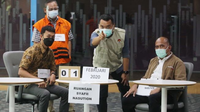 Penyidik KPK asal Lampung Praswad Nugraha (tunjuk tangan) saat rekonstruksi perkara Bansos COVID-19. [ISTIMEWA]