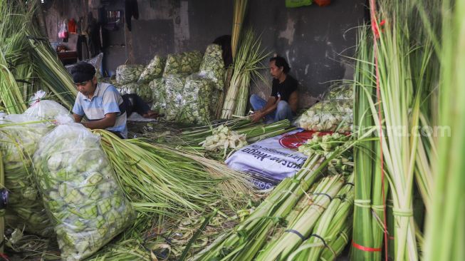 Aktivitas para pedagang kulit ketupat di Pasar Palmerah, Jakarta Pusat, Minggu (18/7/2021). [Suara.com/Alfian Winanto]