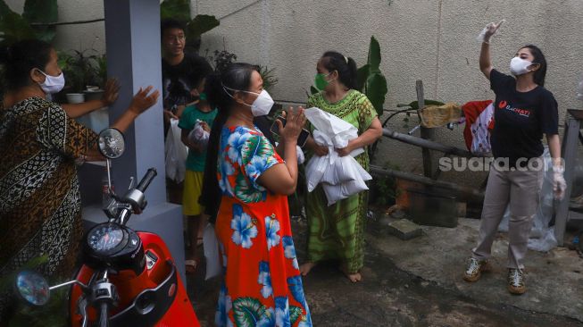 Pedangdut Dewi Perssik pamit kepada warga usai membagikan paket bantuan berupa daging kurban dan sembako kepada warga di sekitar rumahnya di Kawasan Fatmawati, Jakarta Selatan, Selasa (20/7/2021). [Suara.com/Alfian Winanto]