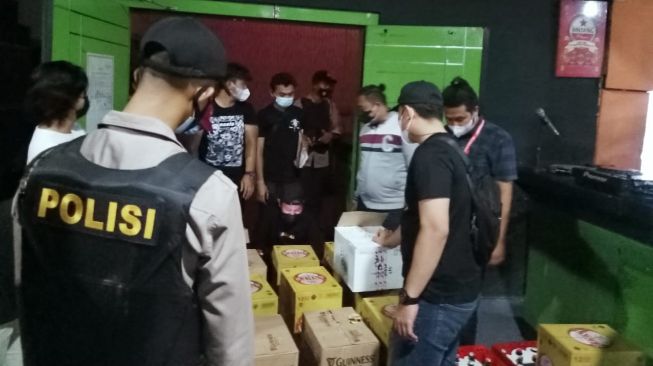 Polisi sita miras di tempat hiburan malam di JLS yang masih buka saat PPKM. [Suara.com/Oki Faturrohman]