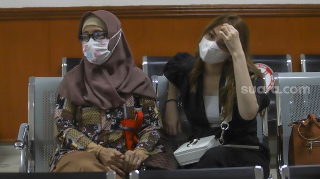 Aktris Aisyah Aqilah (kanan) bersama Ibunda dari Jeff Smith, Areistiani (kiri) saat datang mengikuti jalannya sidang kasus narkoba yang menjerat kekasihnya, Jeff Smith di Pengadilan Negeri Jakarta Barat, Rabu (4/8/2021). [Suara.com/Alfian Winanto]