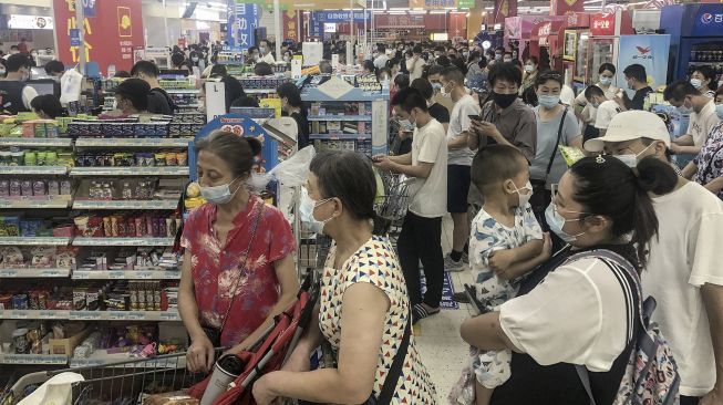 Orang-orang membeli barang di supermarket di Wuhan, Provinsi Hubei, China, pada (2/8/2021). [STR / AFP]