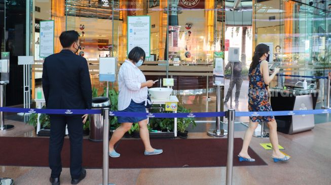 Warga berjalan masuk ke Pondok Indah Mall, Jakarta Selatan, Minggu (15/8/2021). [Suara.com/Alfian Winanto]