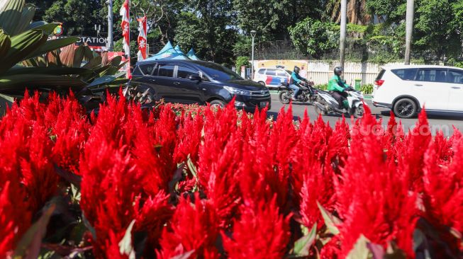 Dekorasi bunga bernuansa merah putih terpajang di kawasan Bundara Hotel Indonesia (HI), Jakarta Pusat, Senin (16/8/2021). [Suara.com/Alfian Winanto]