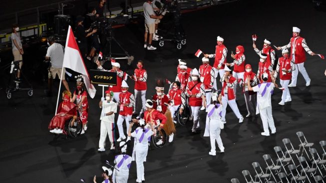 Tim Indonesia saat mengikuti defile atau parade atlet dalam upacara pembukaan Paralimpiade Tokyo 2020 di Stadion Olimpiade Tokyo pada 24 Agustus 2021.CHARLY TRIBALLEAU / AFP