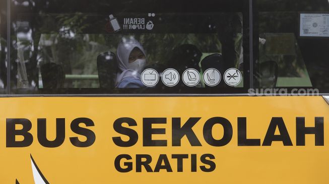 Pelajar menaiki Bus Sekolah Gratis usai mengikuti pembelajaran tatap muka (PTM) di SMK Negeri 15 Jakarta, Kebayoran Baru, Jakarta Selatan, Jumat (3/9/2021). [Suara.com/Angga Budhiyanto]