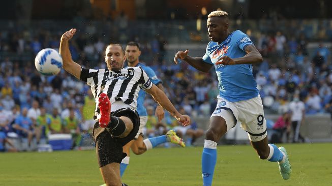 Bek Juventus Giorgio Chiellini (kiri) berebut bola dengan pemain depan Napoli Victor Osimhen (kanan) selama pertandingan sepak bola Serie A antara Napoli dan Juventus di Stadion Maradona, Naples, Italia, pada (11/9/2021). [Carlo Hermann / AFP]