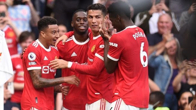 Jesse Lingard, Cristiano Ronaldo, Paul Pogba merayakan gol usai laga MU vs Newscastle United. (AFP/Oli Scarff)
