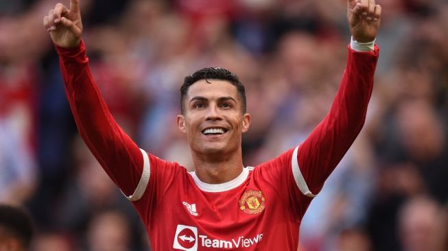 Ekspresi megabintang Manchester United, Cristiano Ronaldo usai mencetak gol dalam laga Liga Inggris kontra Newcastle United di Old Trafford, Manchester, Sabtu (11/9/2021) malam WIB. [OLI SCARFF / AFP]