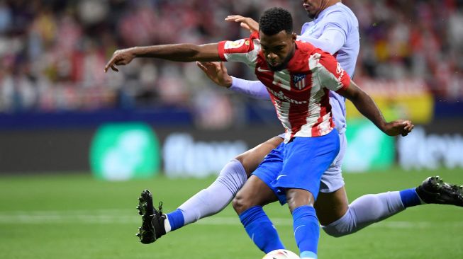 Gelandang Atletico Madrid Thomas Lemar mencetak gol selama selama pertandingan sepak bola Liga Spanyol antara Atletico Madrid melawan Barcelona di stadion Wanda Metropolitano Madrid, Spanyol,  Minggu (3/10/2021) dini hari WIB. OSCAR DEL POZO / AFP
