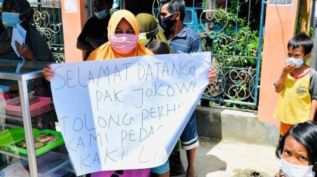 Bentangkan Tulisan Saat Presiden Melintas di Sorong, Ibu-ibu Ini Dihampiri Langsung Jokowi