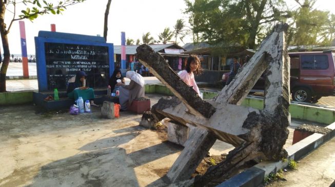 Tugu peringatan tsunami yang didirikan pemerintah daerah di Pantai Widarapayung, Kabupaten Cilacap, Kamis (7/10/2021). [Suara.com/Anang Firmansyah]