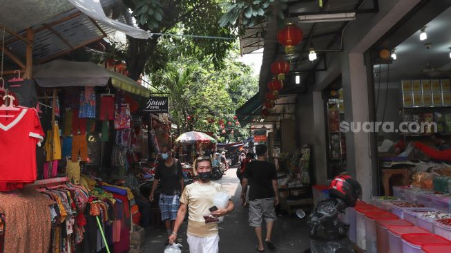 Warga beraktivitas di kawasan Glodok, Jakarta Barat, Minggu (10/10/2021). [Suara.com/Alfian Winanto]