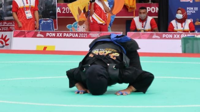 Atlet silat Pipiet Kamelia sujud syukur usai pertandingan di Gedung Olahraga (GOR) Toware Kabupaten Jayapura, Selasa. (ANTARA/Muhammad Zulfikar).