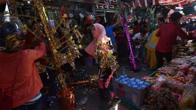 Warga berebur telur pada pohon telur hias saat perayaan peringatan Maulid Nabi Muhammad SAW di Pasar Tradisional Masomba di Palu, Sulawesi Tengah, Senin (18/10/2021). ANTARA FOTO/Mohamad Hamzah
