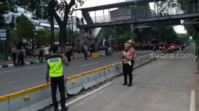 Petugas kepolisian bersiaga di Jalan Merdeka Barat terkait adanya aksi massa dari Badan Eksekutif Mahasiswa Seluruh Indonesia (BEM SI), Kamis (21/10/2021). [Dok. Raihan Hanani]