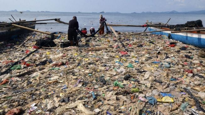 Nelayan beraktifitas di antara tumpukan sampah di pantai Sukaraja Bandar Lampung, Lampung, Jumat (22/10/2021).  ANTARA FOTO/Ardiansyah
