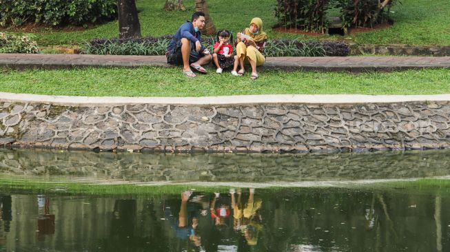 Sejumlah warga bersantai di Taman Spatodhea, Jakarta Selatan, Sabtu (23/10/2021). [Suara.com/Alfian Winanto]