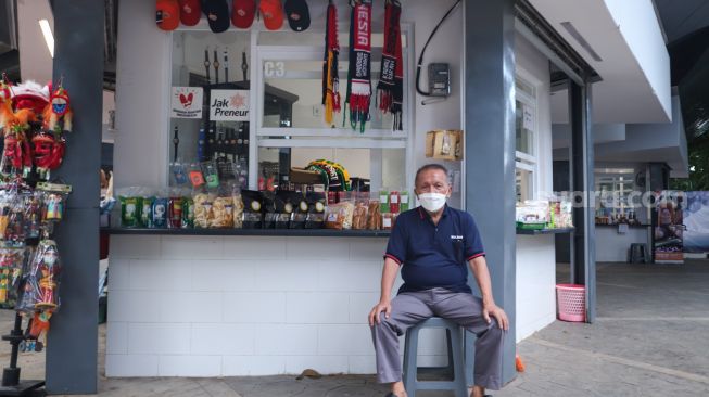 Seorang pelaku usaha mikro, kecil, dan menengah (UMKM) berjaga di depan kiosnya di kawasan terpadu Stasiun Tebet, Jakarta Selatan, Selasa (1/11/2021). [Suara.com/Alfian Winanto]