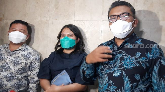 Laura Aprilya Bakkara (tengah) bersama pengacaranya, Rinto Maha usai menjalani pemeriksaan di Polda Metro Jaya, terkait kasusnya dengan Shandy Aulia, Kamis (11/11/2021). [Evi Ariska/Suara.com]
