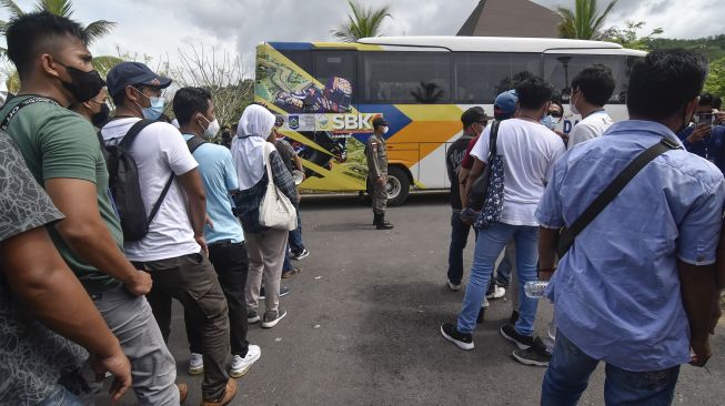 Sejumlah warga antre menaiki bus yang akan menuju Pertamina Mandalika International Street Circuit di KEK Mandalika, Praya, Lombok Tengah, NTB, Sabtu (13/11/2021). [ANTARA FOTO/Ahmad Subaidi]