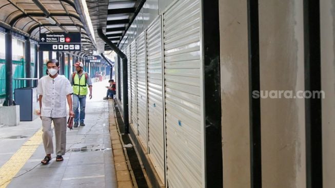 Warga melintas di depan ruko UMKM di Stasiun Gondangdia, Jakarta Pusat, Selasa (16/11/2021).[Suara.com/Alfian Winanto]