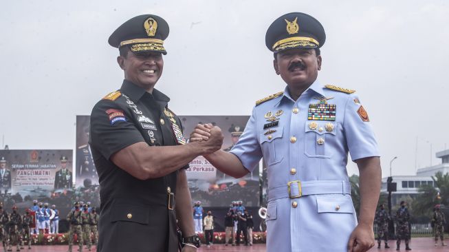 Pejabat baru Panglima TNI Jenderal TNI Andika Perkasa (kiri) melakukan salam komando dengan pejabat lama Panglima TNI Marsekal TNI Hadi Tjahjanto (kanan) usai upacara Serah Terima Jabatan Panglima TNI di Mabes TNI, Cilangkap, Jakarta, Kamis (18/11/2021).  ANTARA FOTO/Muhammad Adimaja