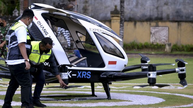 Petugas melakukan pemeriksaan taksi terbang EHang 216 sebelum menjalani 'demo flight' di wilayah Klungkung, Bali, Jumat (26/11/2021). [ANTARA FOTO/Fikri Yusuf]