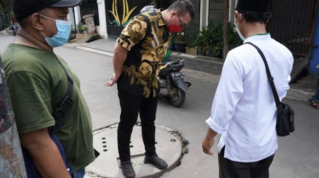 Anggota DPRD DKI Jakarta dari Fraksi PDIP Hardiyanto Kenneth saat memeriksa sumur resapan di Jakarta. [Dok. Hardiyanto Kenneth]