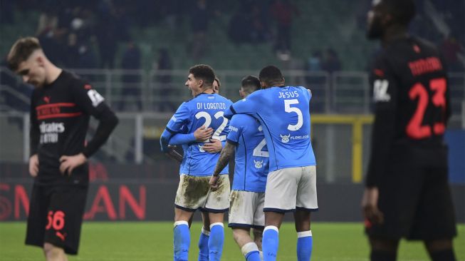 Bek Napoli Giovanni Di Lorenzo dan rekan satu timnya merayakan kemenangan di akhir pertandingan sepak bola Serie A Italia antara AC Milan dan Napoli di stadion San Siro, Milan, pada (19/12/2021). [MIGUEL MEDINA / AFP]