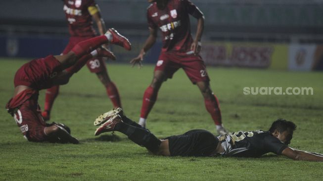 Gelandang Martapura Dewa United Gufroni Al Maruf terjatuh selama pertandingan semifinal Liga 2 antara Martapura Dewa United melawan Persis Solo di Stadion Pakansari, Bogor, Jawa Barat, Senin (27/12/2021). [Suara.com/Angga Budhiyanto]