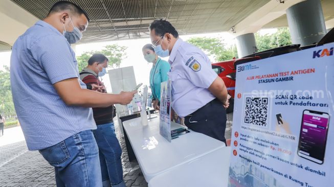 Penumpang mendaftar untuk Rapid Tes Antigen di Stasiun Gambir, Jakarta Pusat, Sabtu (1/1/2022). [Suara.com/Alfian Winanto]