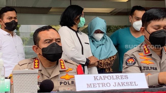 Pedangdut Velline Chu (berkerudung ibur muda) dihadirkan Polres Jakarta Selatan dalam kasus narkoba jenis sabut, Senin (10/1/2022). Velline ditangkap bersama suaminya, Budi Hartono di kediamannya di kawasan Bekasi, Jawa Barat, 8 Januari 2022. [Yuliani/Suara.com]