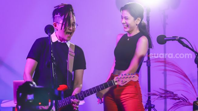 Aksi grup musik Black Champagne ketika tampil saat berkunjung kantor redaksi Suara.com di Kuningan, Jakarta Selatan, Senin (10/1/2021). [Suara.com/Alfian Winanto]