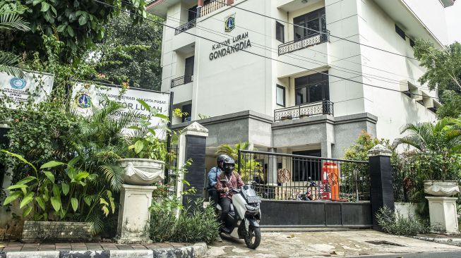 Warga mengendarai sepeda motor keluar gerbang Kantor Kelurahan Gondangdia, Jakarta, Rabu (19/1/2022). ANTARA FOTO/Muhammad Adimaja