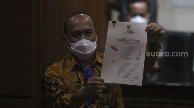 Kabiro Hukum dan Humas Mahkamah Agung Sobandi menunjukkan surat pemberhentian sementara Hakim Pengadilan Negeri (PN) Surabaya Itong Isnaini Hidayat saat konferensi pers di Gedung Merah Putih KPK, Jakarta (20/1/2022) malam. [Suara.com/Angga Budhiyanto] 