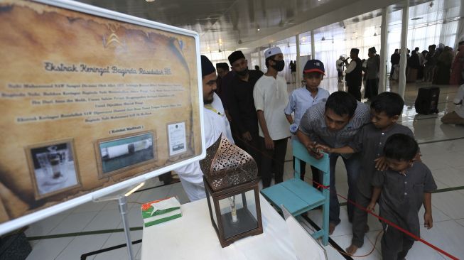 Sejumlah pengunjung melihat barang-barang peninggalan Nabi Muhammad SAW pada pameran artefak di kompleks Yayasan Zawiyah Nurun Nabi, Desa Lambhuk, Banda Aceh, Aceh, Sabtu (22/1/2022). [ANTARA FOTO/Syifa Yulinnas]