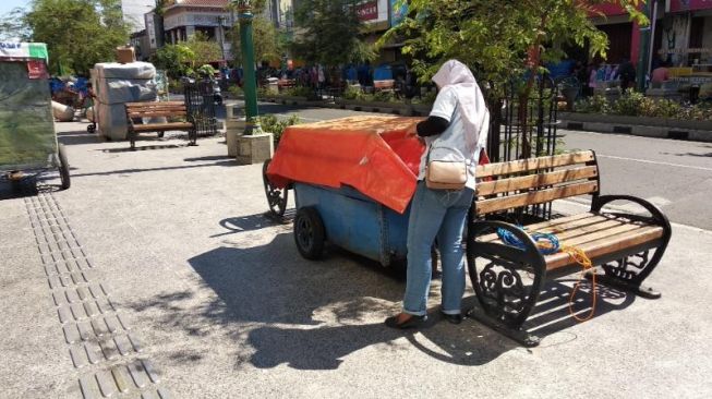 Sejumlah orang tengah mendorong gerobak untuk ditata di tempat berjualan PKL di Malioboro, Kota Jogja, Kamis (27/1/2022). [Muhammad Ilham Baktora / SuaraJogja.id]