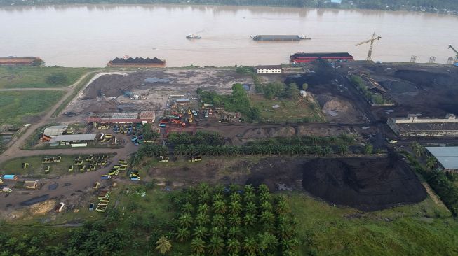 Foto udara suasana aktivitas industri penumpukan batu bara di Kawasan Cagar Budaya Nasional (KCBN) Muarajambi, Taman Rajo, Muarojambi, Jambi, Sabtu (29/1/2022). [ANTARA FOTO/Wahdi Septiawan]