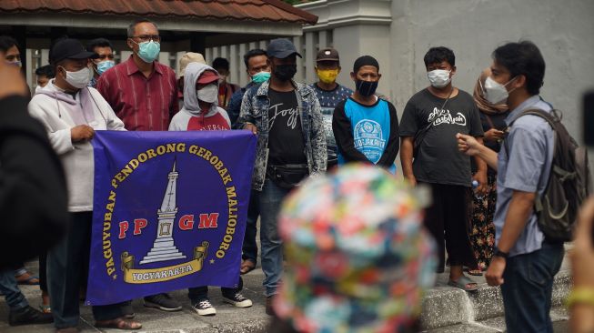 Warga yang tergabung dalam paguyuban pendorong gerobak PKL Malioboro melakukan aksi damai di depan Kantor Gubernur DIY, Yogyakarta, Senin (31/1/2022). ANTARA FOTO/Andreas Fitri Atmoko