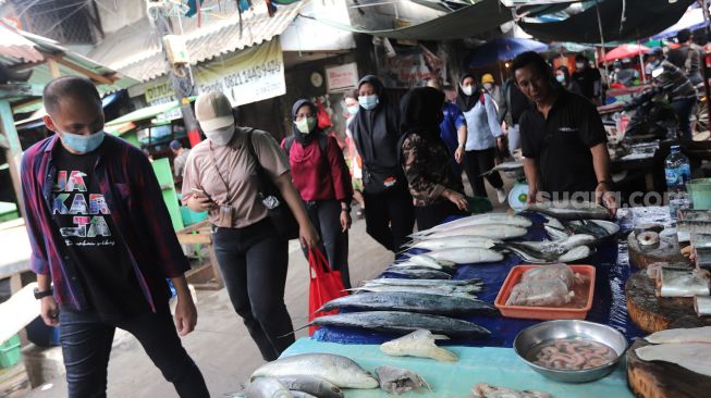 Peserta mengikuti Tur Pecinan Jakarta di Pasar Petak Sembilan, Glodok, Jakarta, Minggu (6/2/2022). [Suara.com/Angga Budhiyanto]