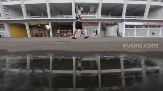 Warga berolahraga di kompleks Gelora Bung Karno, Senayan, Jakarta, Minggu (13/2/2022). [Suara.com/Angga Budhiyanto]