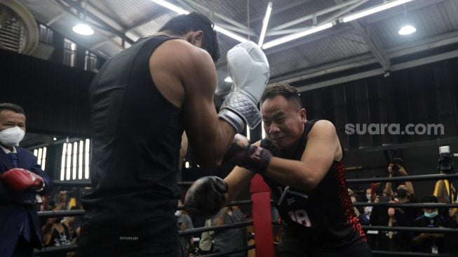 Presenter Vicky Prasetyo beradu tinju (boxing) dengan peraih medali emas PON Papua 2020 Jekson Karmela di United Gym, Cengkareng, Jakarta, Senin (14/2/2022). [Suara.com/Angga Budhiyanto]