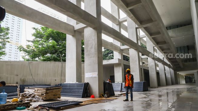 Pekerja menyelesaikan pembangunan proyek revitalisasi Taman Ismail Marzuki di Cikini, Jakarta Pusat, Jumat (18/2/2022). [Suara.com/Alfian Winanto]