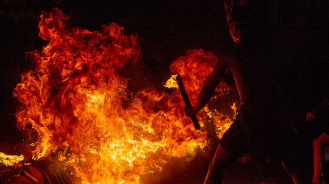 Penari melakukan atraksi api sebagai bagian Tari Atraksi Mandau Bekasai Api pada Festival Budaya Dayak Maanyan Warukin di Desa Warukin, Kabupaten Tabalong, Kalimantan Selatan, Sabtu (19/2/2022). [ANTARA FOTO/Bayu Pratama S/aww]