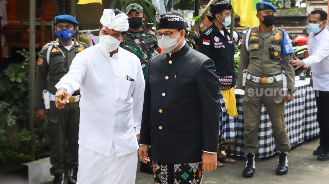 Gubernur DKI Jakarta Anies Baswedan (kanan) saat menghadiri Upacara Tawur Agung Kesanga di Pura Aditya Jaya, Rawamangun, Jakarta Timur, Rabu (2/3/2022). [Suara.com/Alfian Winanto]