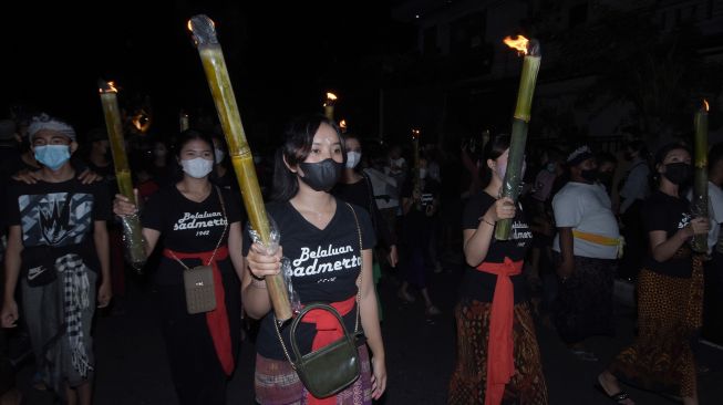 Umat Hindu membawa obor saat pawai ogoh-ogoh menyambut Hari Raya Nyepi Tahun Baru Saka 1944 di Denpasar, Bali, Rabu (2/3/2022). ANTARA FOTO/Nyoman Hendra Wibowo
