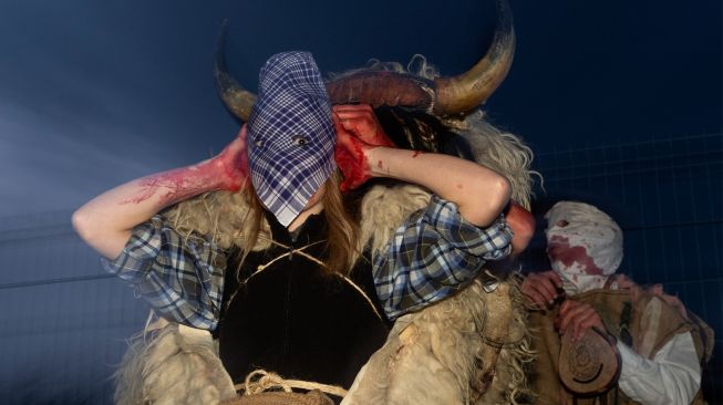 Orang-orang mengenakan kostum Momotxorro saat karnaval tradisional Alsasua di Alsasua, provinsi Navarra, Spanyol, Selasa, (1/3/2022). [ANDER GILLENEA / AFP]
